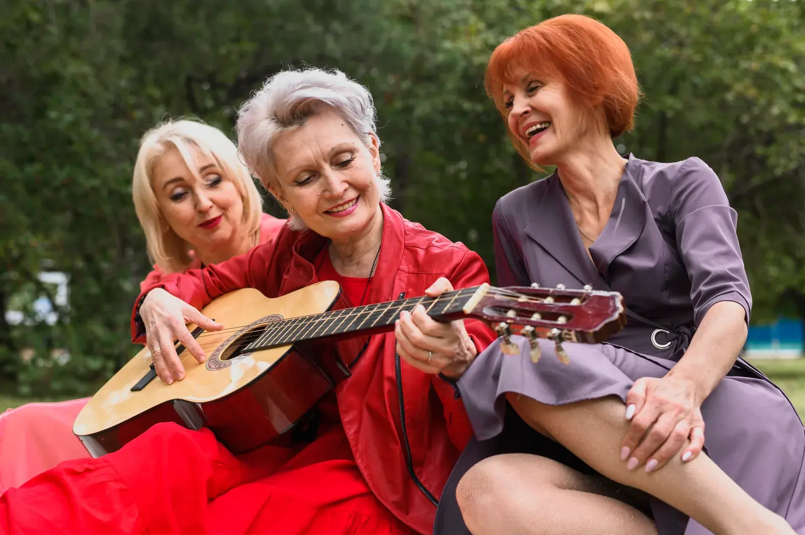 Three women enjoying music together outdoors
