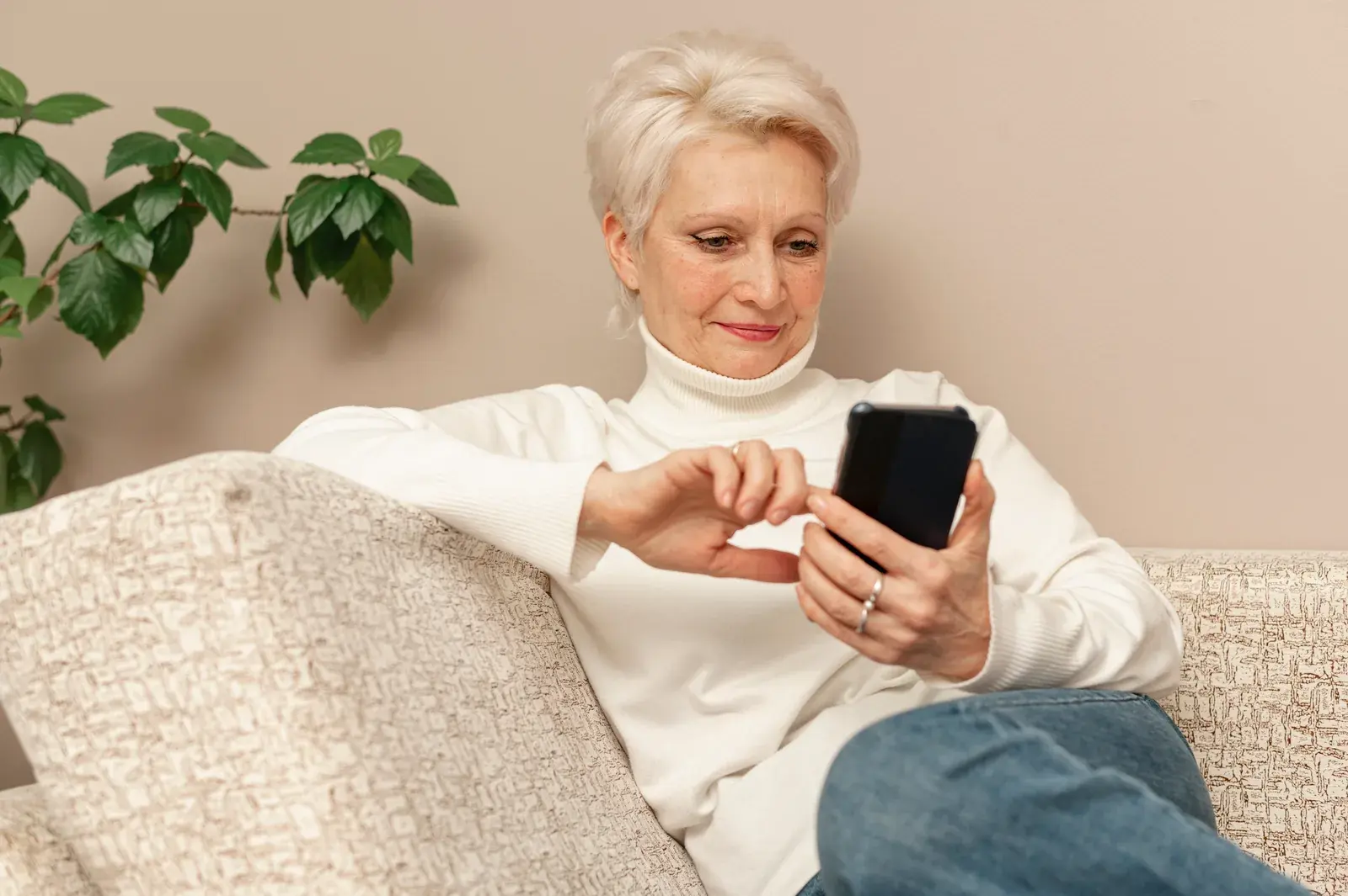 A woman sitting on a sofa using her phone